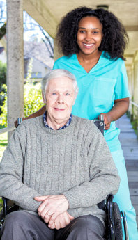 senior male and caregiver smiling
