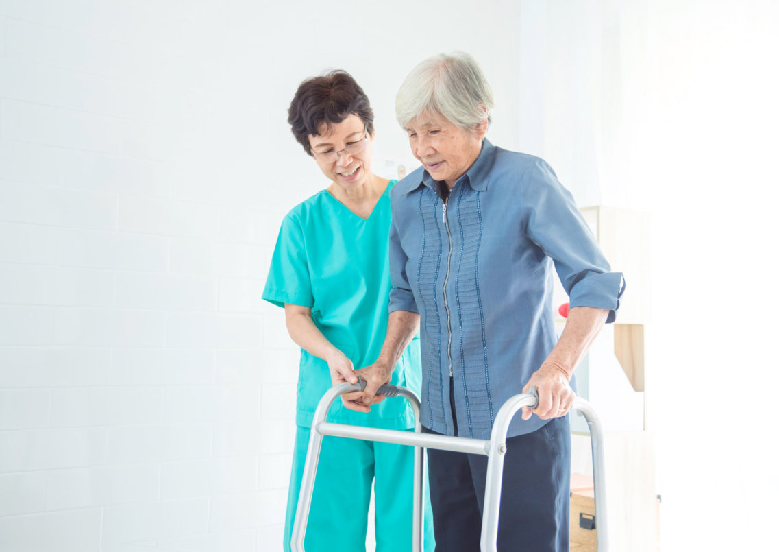 caregiver guiding a senior woman